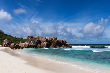Beautiful turquoise water beach Anse Cocos in the seychelles (La Digue).