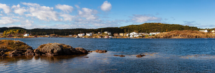 Panoramic View of a small town on the Atlantic Ocean Coast during a cloudy evening. Taken in Toogood Arm, Newfoundland and Labrador, Canada.