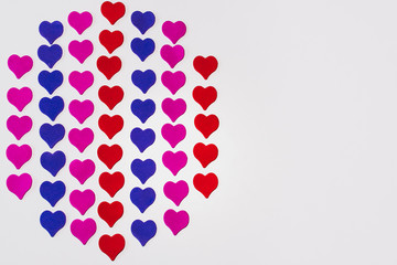 Valentine's day background. Colored little hearts on a white background. Copyspace.