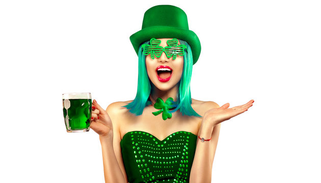 St. Patrick's Day. Leprechaun model girl with pint of green beer over white background. Patrick Day celebration