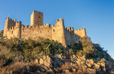 Fototapeta na wymiar 12th century Almourol castle lit by the late afternoon sun with blue sky.