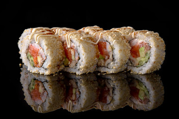 Sushi roll with salmon, smoked eel, shrimp, avocado, unagi sauce on black background. Sushi menu. Japanese food.