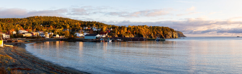 Small town on the Atlantic Ocean Coast during a vibrant sunrise. Taken in Beachside, Newfoundland,...
