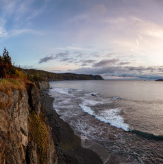 Striking panoramic landscape view of a rocky Atlantic Ocean Coast during a vibrant sunrise. Taken at Beachside, Newfoundland and Labrador, Canada.