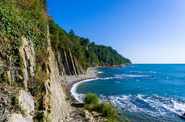 sea landscape is a pebbly beach with waves in white foam