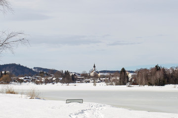 View in winter over the frozen lake Soier to the spa district in Bad Bayersoyen in Germany