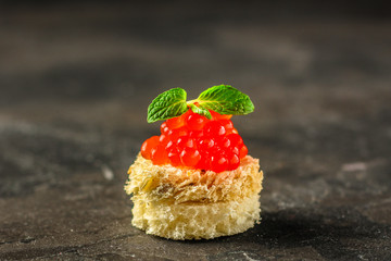 red caviar (canapés or a red snack sandwich). food background. top view