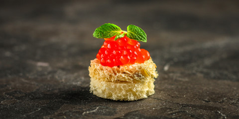 red caviar (canapés or a red snack sandwich). food background. top view