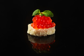 red caviar (canapés or a red snack sandwich). food background. top view