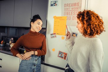 Curly red-haired roommate speaking about cleaning schedule
