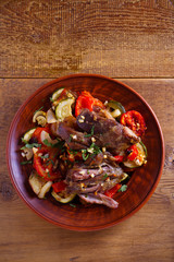 Slow cooker lamb with tomatoes, zucchini, eggplant, onion and garlic. overhead, vertical