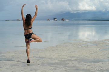Fototapeta na wymiar Asian woman standing, overlooking the ocean at Manjuyod Sandbar, Philippines