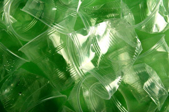 Used Plastic Cup On Green Background, Recycling Concept, Minimal Design