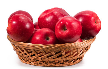 Ripe red apple in wicker basket isolated on white
