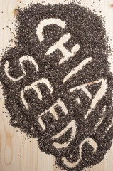 chia word made from chia seeds on wooden artist canvas