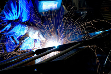 Welder.  Sparks of light.