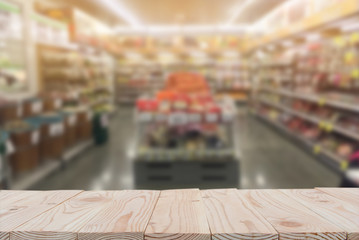 Empty wooden board table top on of blurred supermarket background. with copy space for display or montage your products