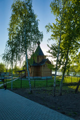 Fototapeta premium MOSCOW, RUSSIA - MAY 10, 2018: Brateevsky cascade park on the bank of the Moscow River. Wooden church by the pond