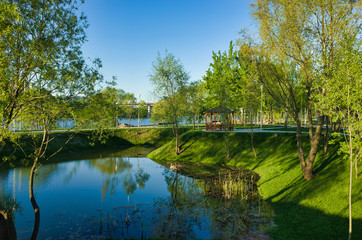 MOSCOW, RUSSIA - MAY 10, 2018: Brateevsky Park. Place of recreation and entertainment, a wooden gazebo by the pond