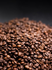 Coffee in beans on dark background. Abstract Food background texture, roasted coffee beans