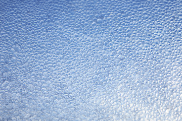 Natural winter background of blue ice drops