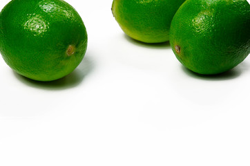 Juicy green limes are on a white background