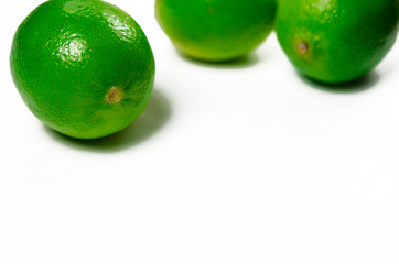Juicy green limes are on a white background