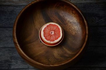 Fresh grapefruit in wooden bowl. Top view