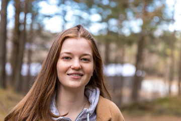 Naklejka premium Smiling girl in the green spring forest