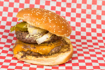 Double Pattie Cheeseburger on Sesame Seed Bun with Pickles, Onion and Mustard