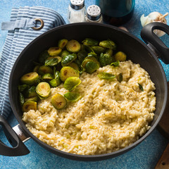 Italian spring risotto with Brussels sprouts and parmesan cheese on the table. healthy food for the whole family, party or restaurant menu