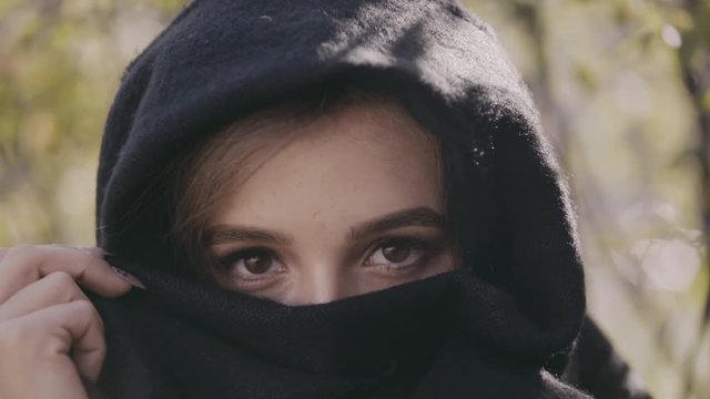 Portrait of the woman with passionate eyes looks through the paranja. 4K