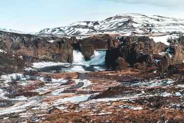 Famous Hjalparfoss double waterfall in southern Iceland with sky and clouds. treking in Iceland....