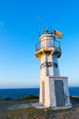 Fototapeta na wymiar Lighthouse on background of blue clear sky