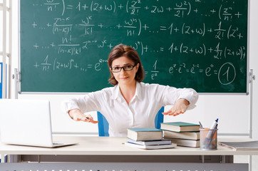 Female math teacher in front of the chalkboard
