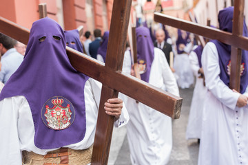 Nazarenos carrying wooden crosses during Easter procession at Sevilla, Spain