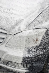 Manual car wash. Washing luxury vehicle with high pressure water pump.Automobile cleaning self...