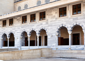 Naklejka premium the architectural part of the building, in the national style, the arches are decorated with marble and lattice windows, natural stone trim