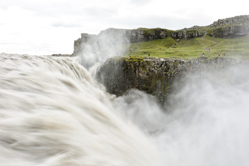 Fresh clean Dettifoss waterfall  in Iceland in  summer with loads of water flowing and mist, water in motion blur