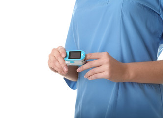 Female doctor using heart rate monitor on white background, closeup. Medical object