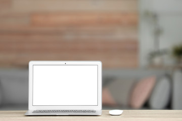 Fototapeta premium Laptop with blank screen on table indoors. Space for text