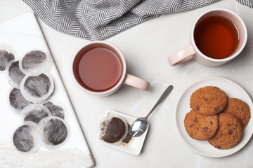 Flat lay composition with fresh tea and cookies on table