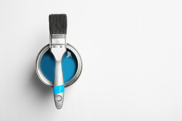 Paint can and brush on white background, top view. Space for text