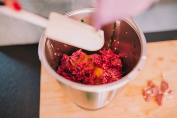 a person cooking minced meat in a beautiful kitchen