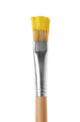 Brush with yellow paint on white background
