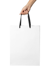 Woman holding paper shopping bag isolated on white, closeup