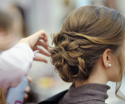 Young woman/bride getting her hair done before wedding or party