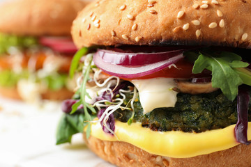 Tasty vegetarian burger with spinach cutlet, closeup
