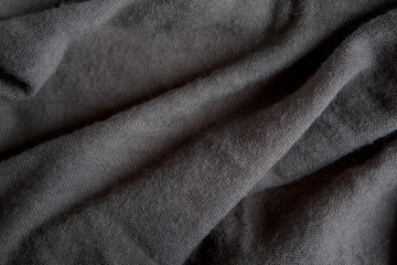 Texture of natural knitted fabric. Texture of gray wool fabric with pleats for design