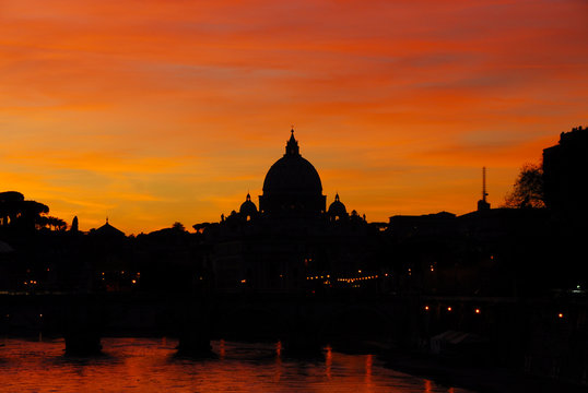 Beautiful sunset along River Tiber in Rome with St Peter dome